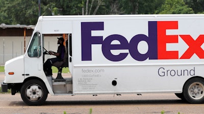 In this June 25, 2019, file photo, a FedEx Ground package van pulls into a business driveway in this north Jackson, Miss., facility. Amazon is banning its third-party merchants from using FedEx's ground service to deliver to Prime members, suggesting that it thinks the service is too slow to get packages to their destinations in time for Christmas.