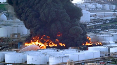 In this Monday, March 18, 2019 file photo, Firefighters battle a petrochemical fire at the Intercontinental Terminals Company in Deer Park, Texas. A fire at a Houston-area petrochemical storage facility that burned for days in March was accidental and caused by equipment failure at a storage tank, according to a report released by local and federal investigators, Friday, Dec. 6, 2019.