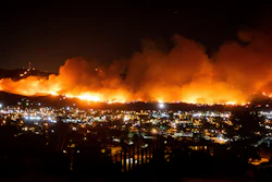 In this Oct. 31, 2019, file photo, smoke from a wildfire known as the Maria Fire billows above Santa Paula, Calif. A new technology being tested by California utilities is aimed at diagnosing problems before they could cause power outages or spark wildfires. The technology invented by Texas A&M University was designed to provide greater reliability for utility customers, but its biggest selling point could be its use in preventing disasters.