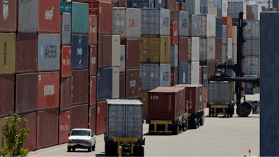 In this July 22, 2019, file stacked containers wait to be loaded on to trucks at the Port of Oakland in Oakland, Calif. China's government says trade negotiators are in “close communication” with Washington ahead of a weekend deadline for a U.S. tariff hike. But a Ministry of Commerce spokesman gave no indication of possible progress in trade talks or whether Washington might postpone the increase.