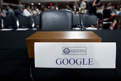 In this Sept. 5, 2018, file photo, an empty chair reserved for Google's parent Alphabet, which refused to send its top executive, is seen before the Senate Intelligence Committee hearing on Capitol Hill in Washington. The co-founders of Google are stepping down as executives of its parent company, Alphabet.