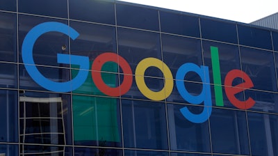In this Sept. 24, 2019, file photo a sign is shown on a Google building at their campus in Mountain View, Calif. Google plans offer checking accounts run by Citigroup and a credit union, according to a report by The Wall Street Journal.