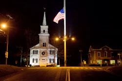 In this Dec. 15, 2012 file photo, a U.S. flag flies at half-staff on Main Street in Newtown, Conn., in honor of the 26 students and staff killed in a shooting at the Sandy Hook Elementary school. Vigils and church services were held Saturday, Dec. 14, 2019, in Newtown to mark the seventh anniversary of the Dec. 14, 2012, shooting and remember victims of other gun violence.