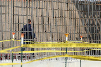 A McAllen K-9 police officer walks past rebar that will make up the border wall before DHS Acting Homeland Secretary Chad Wolf tours and speaks to the local media at the border wall under construction on Thursday, Nov. 21, 2019, south of Donna, Texas.