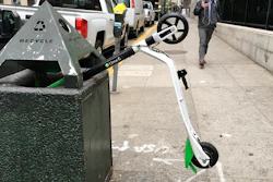 In this photo taken May 14, 2018, a man walks past an electric scooter that was dumped into a trash can in San Francisco. Tired of San Francisco streets being used as a testing ground for the latest delivery technology and transportation apps, city leaders are considering requiring businesses to get permits before trying out new high-tech ideas in public. Supporters of the legislation, which the Board of Supervisors will take up Tuesday, Dec. 10, 2019, say it would be the first of its kind in the U.S. They say it's long overdue in a city that's a hub for major tech companies but is more accustomed to reacting to the sudden arrival of new technology, such as when hundreds of dockless electric scooters appeared overnight last year.