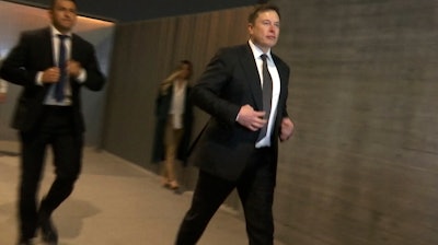 In this frame grab from video, Tesla CEO Elon Musk leaves court, Tuesday, Dec. 3, 2019, in Los Angeles. Musk denied that he meant to call a British cave diver a pedophile when he dubbed him 'pedo guy' on social media.