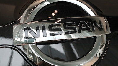 In this Feb. 9, 2017 file photo, the logo of the Nissan Motor Co. is seen on a car displayed at the gallery of its global headquarters in Yokohama, near Tokyo. Japanese securities regulators are recommending that automaker Nissan be fined 2.4 billion yen ($22 million) for the under-reporting of compensation of its former chairman, Carlos Ghosn. The Securities and Exchange Surveillance Commission said Tuesday, Dec. 10, 2019, it made the recommendation to the government's Financial Services Agency.