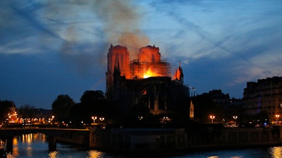 Flames and smoke rise from Notre Dame cathedral in Paris as firefighters tackle the blaze on April 15, 2019.