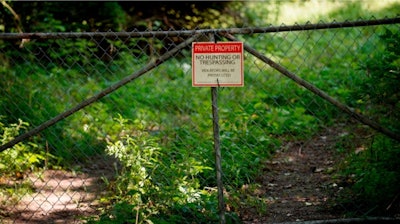 In this Wednesday, Aug. 16, 2017 file photo, a 'No trespassing' sign is displayed at an old tannery waste dump used by Wolverine World Wide in Belmont, Mich. Some private wells in the area have tested positive for elevated levels of per- and polyfluoroalkyl substances called PFAS, also called perfluorinated chemicals, or PFCs. Michigan, where the large city of Flint continues to recover from a lead-tainted water supply, is now racing to combat a new threat to tap water at sites across the state: chemicals long used in firefighting, waterproofing, carpeting and other products.