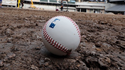 A baseball lies on packed dirt after for a short batting practice during a tour of the under construction baseball field at the new Texas Rangers stadium in Arlington, Texas, Wednesday, Dec. 4, 2019.