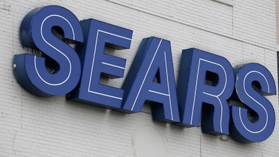 In this Oct. 15, 2018 file photo, a Sears sign is seen in Hackensack, N.J. Sears says it sold the DieHard car battery brand to Advance Auto Parts for $200 million, as the struggling retailer seeks to raise cash. Advance Auto Parts says it will sell DieHard auto batteries in its more than 4,800 stores.