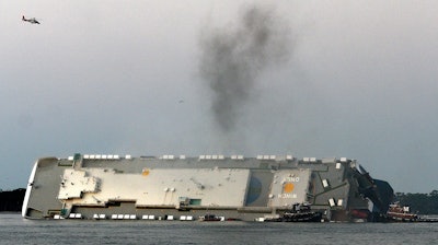 In a Sept. 8, 2019, file photo, smoke rises from a cargo ship that capsized in the St. Simons Island, Georgia sound.