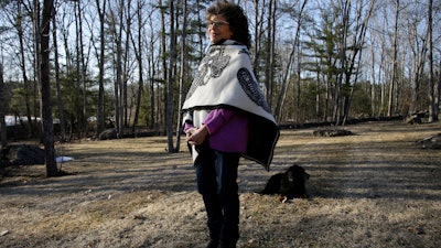 In this March 27, 2019, photo, author Shoshana Zuboff pauses while walking her dog near her home in Maine. Zuboff is the author of 'The Age of Surveillance Capitalism,' a book about how tech companies collect and use personal data.