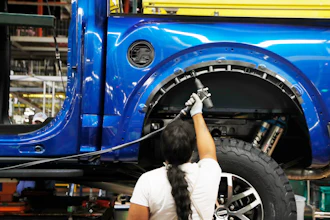 In this Sept. 27, 2018, file photo a United Auto Workers assemblyman works on a 2018 Ford F-150 truck being assembled at the Ford Rouge assembly plant, in Dearborn, Mich. Ford Motor Co. said Tuesday, Dec. 17, 2019, that it is adding 3,000 jobs at two factories in the Detroit area and investing $1.45 billion to build new pickup trucks, SUVs, and electric and autonomous vehicles. At the Dearborn truck plant $700 million will be invested.