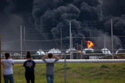 Residents observe the fire consuming the TPC Group plant on Wednesday, Nov. 27, 2019, in Port Neches, Texas. Two massive explosions 13 hours apart tore through the chemical plant Wednesday, and one left several workers injured.