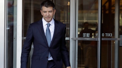 In this Feb. 7, 2018, file photo, former Uber CEO Travis Kalanick leaves federal court in San Francisco. Former Uber CEO Kalanick will resign from the company's board next week, effectively severing ties with the company he co-founded a decade ago.