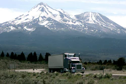 In this June 19, 2008 file photo, a truck drives past Mt. Shasta, near Weed, Calif. California regulators will hold a public hearing on Thursday, Dec. 12, 2019 about whether to require a certain percentage of truck sales to be zero emission vehicles. California has some of the worst air quality in the nation, largely driven by pollution from cars and trucks.