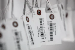 In this Sept. 24, 2015, file photo, tags with bar codes hang at a facility in Flandreau, S.D. George J. Laurer, whose invention of the Universal Product Code at IBM transformed retail and other industries around the world, died Thursday, Dec. 5, 2019, at his home in Wendell, N.C. He was 94.
