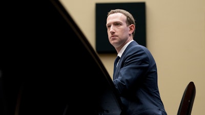 In this April 11, 2018, photo, Facebook CEO Mark Zuckerberg listens to a question as he testifies before a House Energy and Commerce hearing on Capitol Hill in Washington. Facebook is rebuffing efforts by U.S. Attorney General William Barr to give authorities a way to read encrypted messages. The heads of Facebook-owned WhatsApp and Messenger services told Barr and his U.K. and Australian counterparts that Facebook is moving forward with plans to enable end-to-end encryption on all of its messaging services. End-to-end encryption locks up messages so that not even Facebook can read their contents.