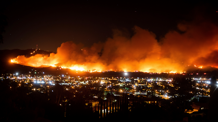 In this Oct. 31, 2019, file photo, smoke from a wildfire known as the Maria Fire billows above Santa Paula, Calif. California's preemptive power shutoffs to prevent wildfires have affected more than just lights. Some lost their phones, too.