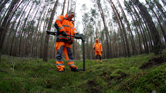In this Wednesday, Jan. 8, 2020 photo members of a bomb disposal team search for World War II munition at the site of the planned new Tesla Gigafactory in Gruenheide near Berlin, Germany.