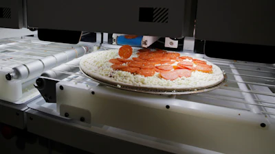 Picnic's pizza-making robot makes a pizza at a food vendor's booth during the CES tech show, Wednesday, Jan. 8, 2020, in Las Vegas.