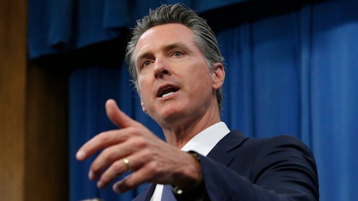 In this July 23, 2019, file photo, Gov. Gavin Newsom talks to reporters at his Capitol office, in Sacramento, Calif. California could become the first state with its own prescription drug label. Newsom announced Thursday, Jan. 9, 2020, he wants California to contract with generic drug companies to make prescription medications on behalf of the state so it can sell them to the public. He said the goal is to lower prices by increasing competition in the generic market. State lawmakers must approve the plan before it can take effect.