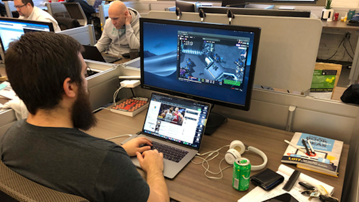 In this undated image provided by Cameron MacMillan, Jordan Davis, foreground, and Jason Wilson and Chad Wright, background work at the Better Collective Tennessee, RotoGrinders.com office in downtown Nashville.