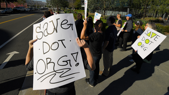 About 15 people protest Friday, Jan. 24, 2020, in Los Angeles outside the headquarters of the regulatory body for domain names, the Internet Corporation for Assigned Names and Numbers. The company that controls the dot-org online universe is putting the registry of domain names up for sale, and the nonprofits that often use the suffix in their websites are raising concerns about the move. ICANN is meeting this weekend and is expected to rule by mid-February on plans by private-equity firm Ethos Capital to buy the Public Interest Registry for $1.1 billion.
