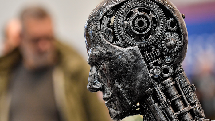 In this Nov. 29, 2019, file photo, a metal head made of motor parts symbolizes artificial intelligence, or AI, at the Essen Motor Show for tuning and motorsports in Essen, Germany. The Trump administration is proposing new rules guiding how the U.S. government regulates the use of artificial intelligence in medicine, transportation and other industries. The White House unveiled the proposals Tuesday, Jan. 7, and said they're meant to promote private sector applications of AI that are safe and fair.