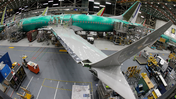 n this March 27, 2019, photo taken with a fish-eye lens, a Boeing 737 MAX 8 airplane sits on the assembly line during a brief media tour in Boeing's 737 assembly facility in Renton, Wash. The looming production shutdown of Boeing 737 Max jets is taking a toll on a key supplier. Spirit AeroSystems Holdings Inc. is asking employees if they will take voluntarily buyouts. Spirit suspended production of fuselages and other parts for the Max on Jan. 1, 2020, after Boeing told the Wichita, Kansas, company to suspend shipments.