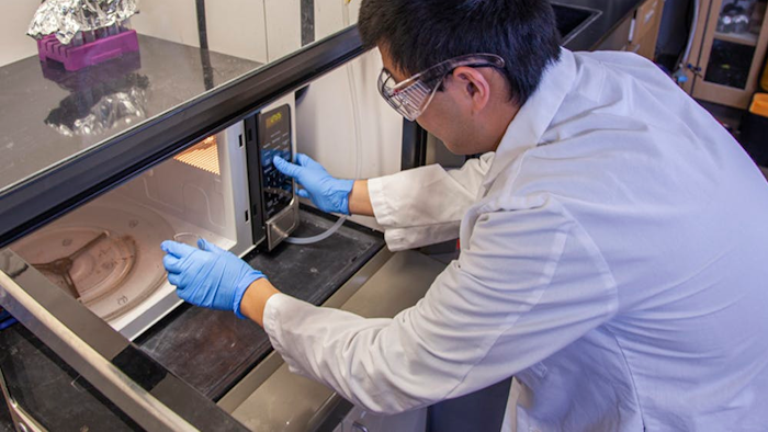 Gang Chen microwaves some biosolids, separating the organic material from the toxic metals.