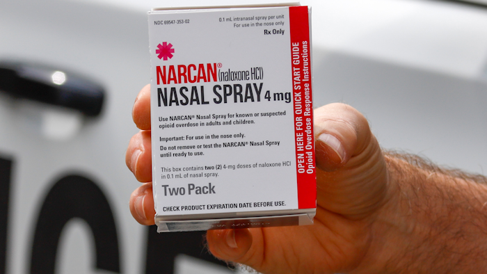 In this Thursday, Sept. 12, 2019 file photo, a police officer holds a box of Narcan, a drug used to treat opioid overdoses, that the department officers carry in their patrol vehicles in Jackson Township, Butler County, Pa. More companies could begin making the easy-to-use version of the medication under a deal announced Thursday, Jan. 2, 2020 by New York's attorney general.