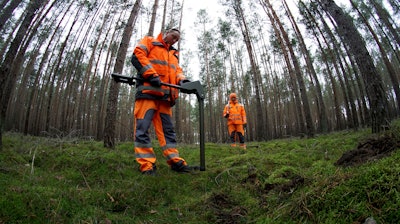 In this Wednesday, Jan. 8, 2020 photo members of a bomb disposal team search for World War II munition at the site of the planned new Tesla Gigafactory in Gruenheide near Berlin, Germany.