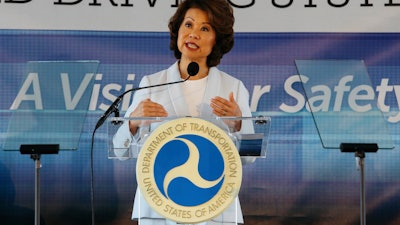 In this Sept. 12, 2017 file photo, U.S. Transportation Secretary Elaine Chao announces new voluntary safety guidelines for self-driving cars during a visit to an autonomous vehicle testing facility at the University of Michigan, in Ann Arbor, Mich. The Trump administration announced its most recent round of guidelines for autonomous vehicle makers, continuing to rely on the industry to police itself despite calls for specific regulations. Chao announced the proposed guidelines in a speech Wednesday, Jan. 8, 2020 at the CES gadget show in Las Vegas, saying in prepared remarks that “AV 4.0” will ensure U.S. leadership in developing new technologies.