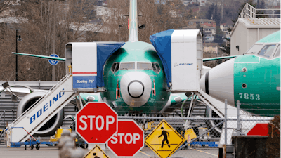 In this Monday, Dec. 16, 2019, file photo, Boeing 737 Max jets sit parked in Renton, Wash. Newly released Boeing documents show that company employees knew about problems with flight simulators for the now-grounded 737 Max jetliner and talked about misleading regulators.