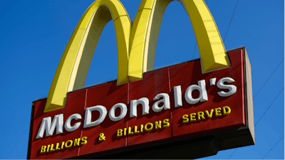 This Nov. 25, 2019, file photo shows McDonald's sign above the fast food restaurant near downtown Los Angeles. The Labor Department issued a final rule Sunday, Jan. 12, 2020, that clarifies when a worker is employed by more than one company, an issue that affects franchise businesses such as McDonald's and firms that have outsourced services such as cleaning and maintenance.