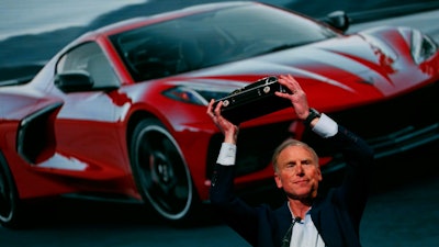 Tadge Juechter, Corvette executive chief engineer, holds up the trophy after the new mid-engine Chevrolet Corvette was named the North American Car of the Year in Detroit, Monday, Jan. 13, 2020. The Kia Telluride took Sport Utility of the Year honors and the Jeep Gladiator won the Truck of the Year Award.
