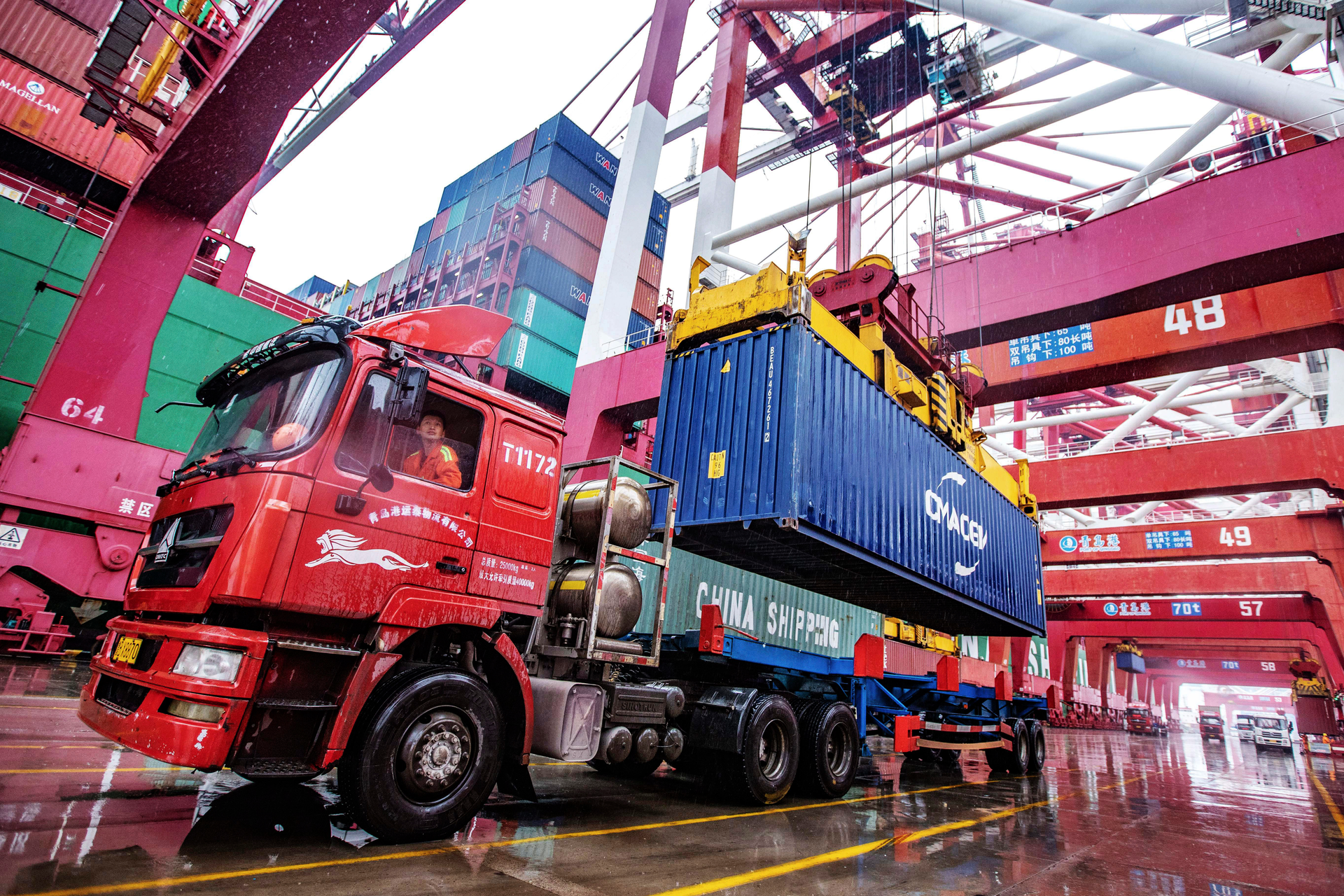 A worker waits to transport containers at the container port in Qingdao in eastern China's Shandong province on Tuesday, Jan. 14, 2020. China's exports rose 0.5% in 2019 despite a tariff war with Washington after growth rebounded in December on stronger demand from other markets.