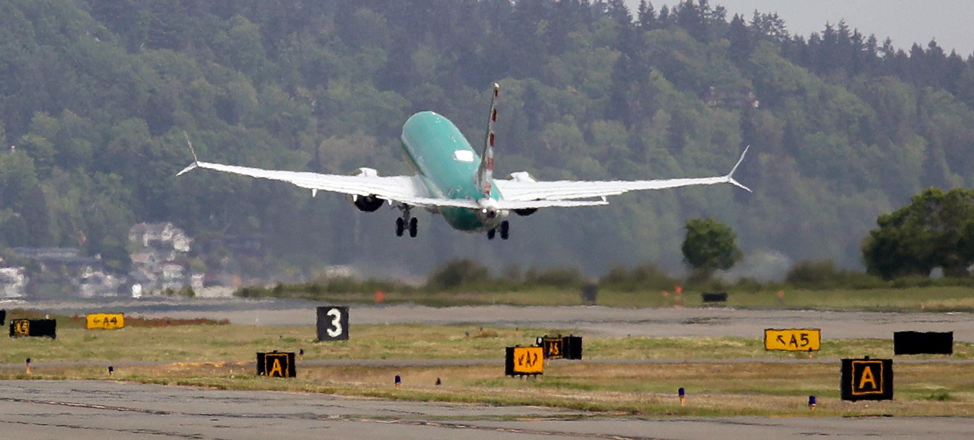 In this May 8, 2019, file photo a Boeing 737 MAX 8, being built for American Airlines, is partially obscured by the engine wash as it takes-off on a test flight in Renton, Wash. A government committee reviewing how the Federal Aviation Administration certifies new passenger planes for flight has determined that the system is safe and effective but small changes need to be made. The committee was appointed by Transportation Secretary Elaine Chao in April after two deadly crashes involving Boeing's 737 Max.