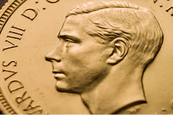 In this undated photo made available by The Royal Mint, a view of a rare Edward VIII Sovereign coin. One of the world's most rare coins featuring the uncle of Britain's Queen Elizabeth II, has been purchased for 1 million pounds ($1.3 million) in a new record for the sale of a British coin. The historical oddity shows King Edward VIII before he abdicated the throne in 1936 in order to marry American divorcee Wallis Simpson. The 22-carat gold coins were never released to the public.