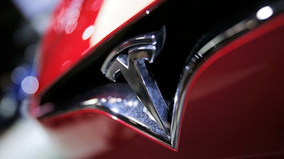 This Sept. 30, 2016, file photo shows the logo of the Tesla model S at the Paris Auto Show in Paris, France. The U.S. government's auto safety agency is looking into allegations that all three of Tesla's electric vehicles can suddenly accelerate on their own. An unidentified person petitioned the National Highway Traffic Safety Administration asking for an investigation into the problem. The agency says the allegations include about 500,000 Tesla Model 3, Model S and Model X vehicles from the 2013 through 2019 model years.