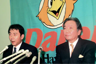 In this December 1998, photo, then Fukuoka Daiei Hawks President Hiroshi Murakami, right, and acting owner Tadashi Nakauchi speak to journalists during a press conference on a suspicion of sign stealing at Fukuoka Dome in Fukuoka, southern Japan.