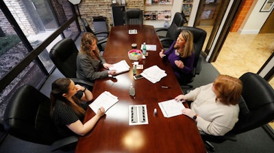 Jo Trizila, top right, President and CEO of Trizcom Public Relations, conducts a meeting with her staff Ann Littmann, right, Noel Hampton, bottom left, and Hayley Swinton at their office in Dallas on Tuesday, Jan. 21. The recent flu outbreak can really impact small businesses with small staffs and hurt a company's productivity. Some owners, like Trizila, are trying to mitigate the damage so the flu will not become a nightmare when they're trying to get clients' work done.