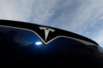 In this Nov. 10, 2019, file photo the company logo shines off the grille of an unsold 2020 Model X at a Tesla dealership in Littleton, Colo.