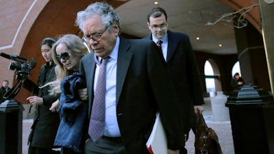 Insys Therapeutics founder John Kapoor, front, departs federal court Thursday, Jan. 23, 2020, in Boston, after he was sentenced to 5 1/2 years in prison for orchestrating a bribery and kickback scheme prosecutors said helped fuel the opioid crisis. He was found guilty the previous May of racketeering and conspiracy in a scheme where millions of dollars in bribes were paid to doctors across the United States to prescribe the company's highly addictive oral fentanyl spray, known as Subsys.