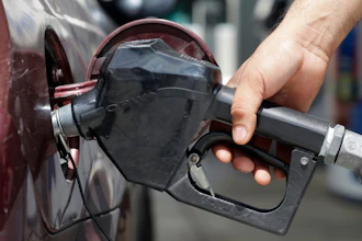 In this June 28, 2016, file photo, a customer puts gas in their vehicle in Miami.