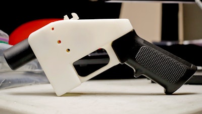 This Aug. 1, 2018 file photo, shows a 3D printed gun called the Liberator, in Austin, Texas. Attorneys general in 20 states and the District of Columbia have filed a lawsuit challenging a federal regulation that could allow blueprints for making guns on 3D printers to be posted on the internet.
