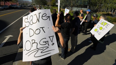 About 15 people protest Friday, Jan. 24, 2020, in Los Angeles outside the headquarters of the regulatory body for domain names, the Internet Corporation for Assigned Names and Numbers. The company that controls the dot-org online universe is putting the registry of domain names up for sale, and the nonprofits that often use the suffix in their websites are raising concerns about the move. ICANN is meeting this weekend and is expected to rule by mid-February on plans by private-equity firm Ethos Capital to buy the Public Interest Registry for $1.1 billion.