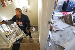 Maria Hernandez climbs her stairwell as she and her family worked to move their belongings out as they sifted through their damaged home in the Bridgeland Lane area of Houston, Sunday, Jan. 26, 2020, after the Watson Grinding Manufacturing explosion early Friday morning. Her ceiling, right, collapsed even further after overnight rains.